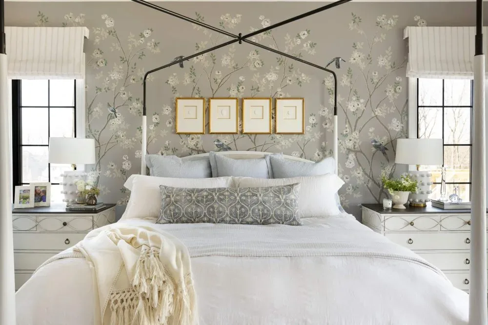Soft Neutral Bedroom with Floral Wallpaper Accent Designed by Decozie Designer Nicole W. Serene bedroom featuring a four-poster bed with white bedding, floral wallpaper accent wall, matching nightstands with white lamps, and soft neutral decor, designed by Decozie designer Nicole W.